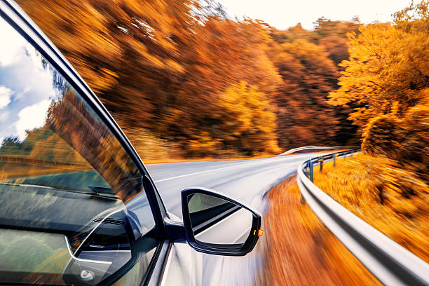 car zooming into fall foliage